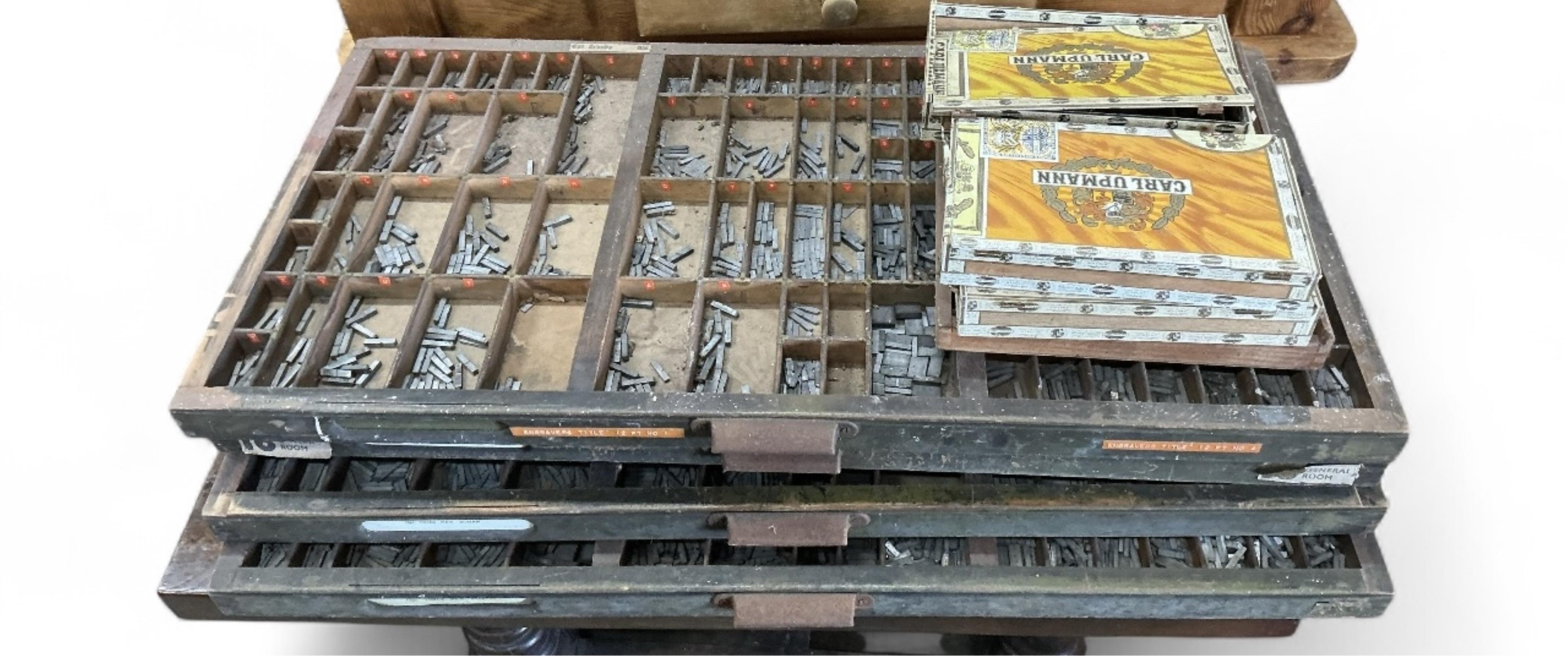 An Adana eight-five printing press with a large quantity of assorted type face, trays, accessories etc.